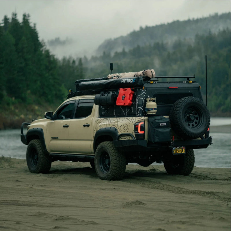 Tan Toyota Tacoma with black topo vinyl wrap
